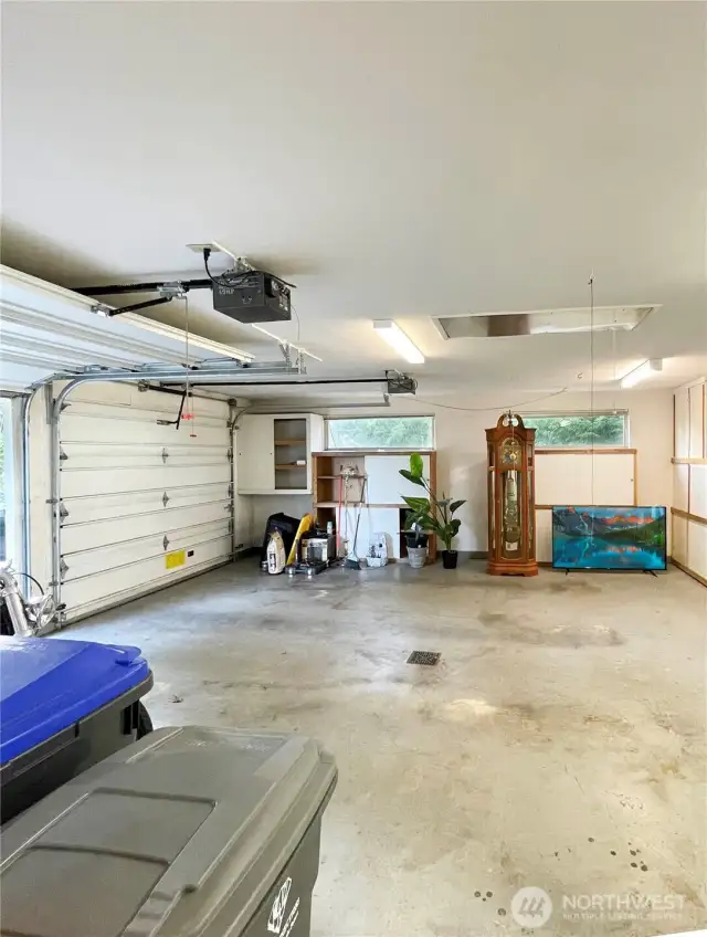 Two car garage with massive cupboards attached to main house.