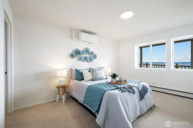 The lower level bedroom is spacious and features ample natural light and water views, plus a walk-in closet.