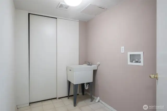 The lower level features a separate laundry room and ample storage space. There is also a built-in vacuum system.