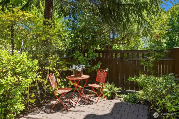 Inviting front corner patio with abundant natural light to enjoy a peaceful cup of tea or space to garden