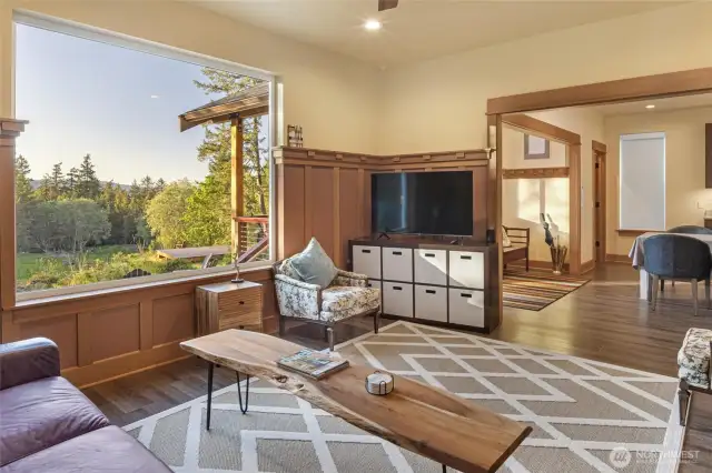 Cozy living space with picture window showcasing beautiful territorial views and warm natural light.