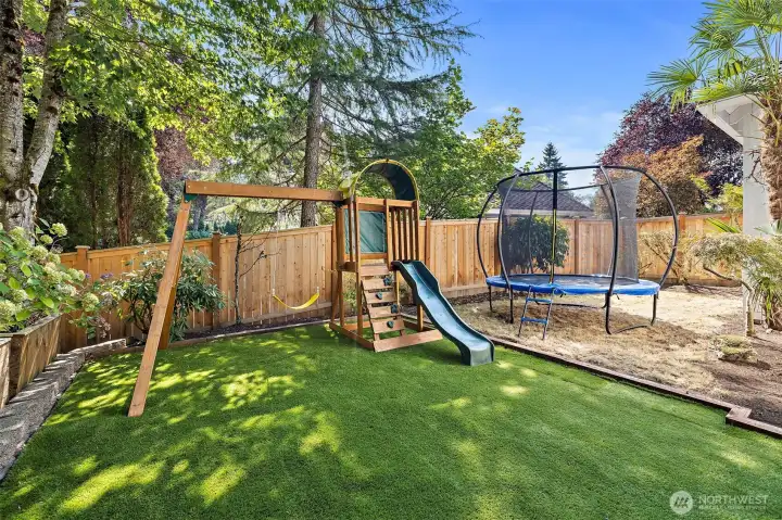 Turf Backyard with Playground and Trampoline