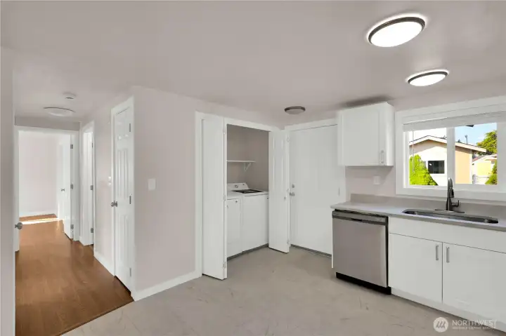 Washer and dryer tucked neatly beside the kitchen for everyday ease.