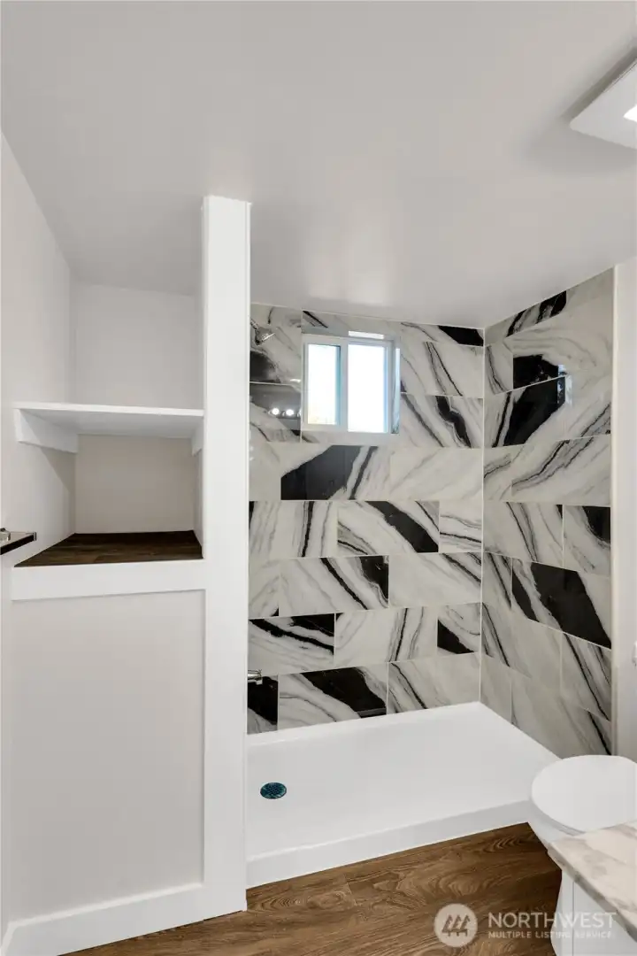 Spacious primary bath with thoughtful storage solutions.