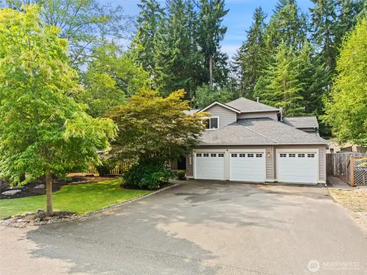Beautiful home in Woods and Meadows with 3 car garage and exquisite landscaping.