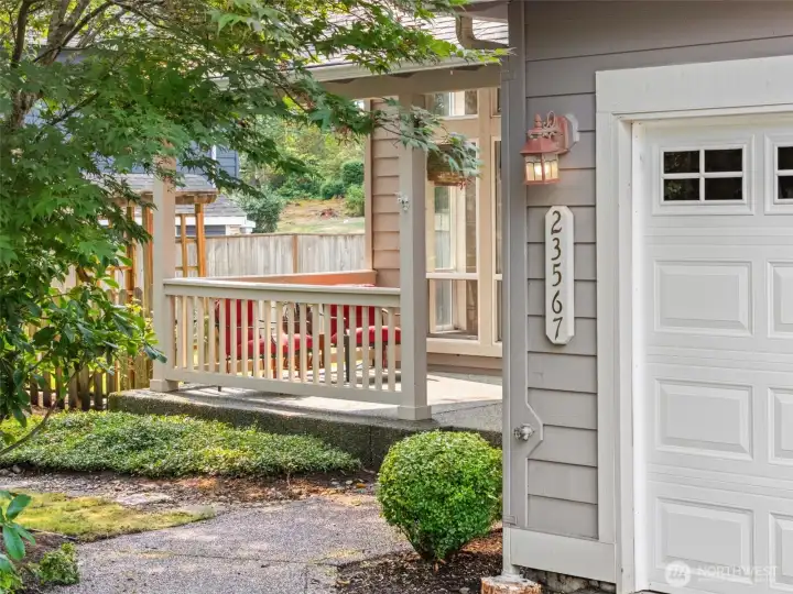 Welcoming front porch and arbor to the left.
