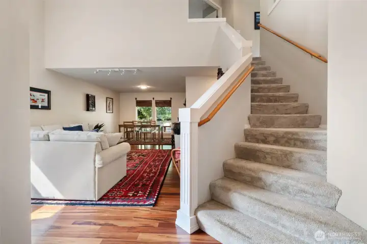 Grand staircase to the 2nd floor. Living room with beautiful hardwood floors.