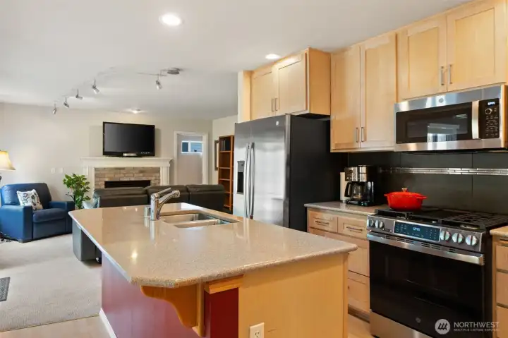 Kitchen is open to the family room and island has a small breakfast bar.