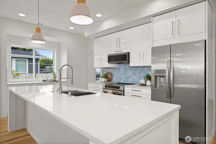 Another view of this beautiful, sleek kitchen with the gorgeous blue tile backsplash that mimics the water.