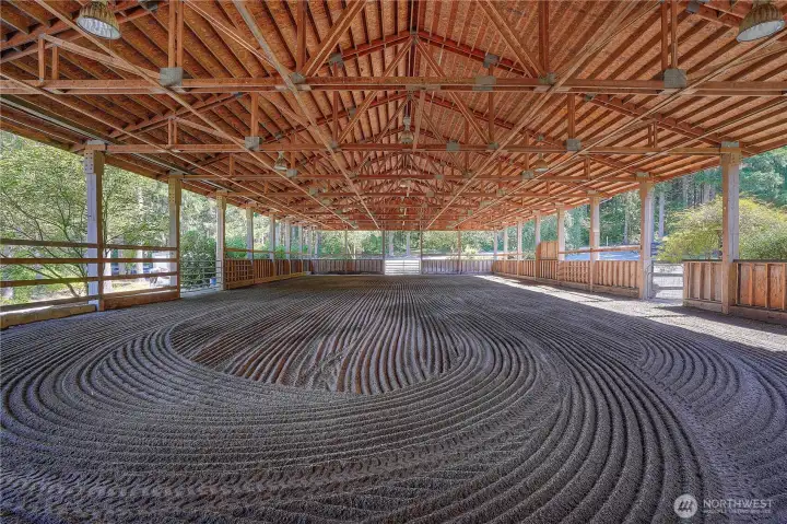 View looking to the East of the 60 X 120 X 16 covered arena. The 16' plate height is perfect to accommodate jumping. Two 12 X 12 entry gates and one service gate.