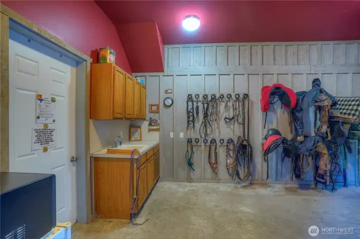 Heated tack/feed/mechanical room with 1/2 bath. The mechanical room houses well pressure tank, water filtration system, water heater, two - 200 AMP electrical panels with genset hookup & toilet