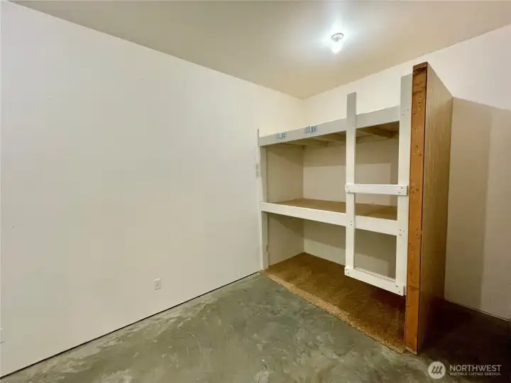 This is a large room which was framed (prior to sheet rock and siding) for a 2nd door and 2 egress windows. Potential for 1 or 2 Bedrooms