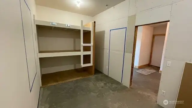 Blue tape shows approximate location of the framed door and windows in this roughed in space.