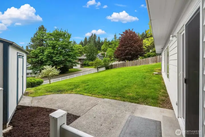 Another view of the backyard with storage shed off to the left.