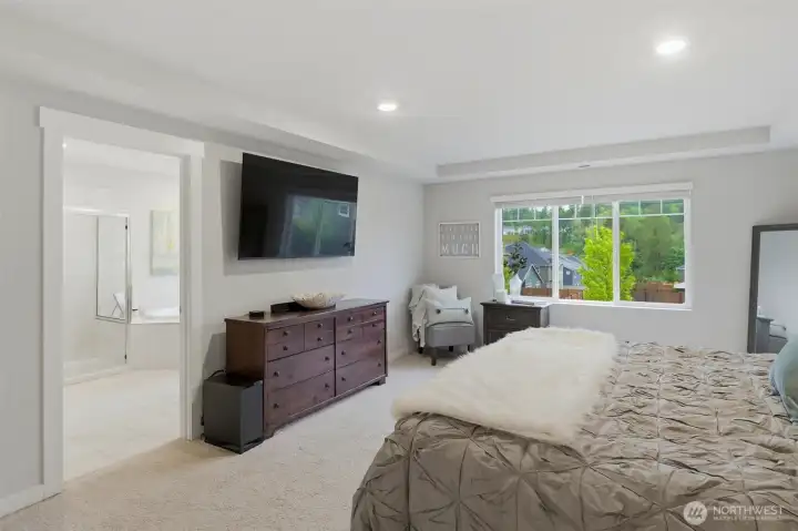 Primary Suite is ! Expansive windows let in light and there are two walk-in closets - one large and one smaller...