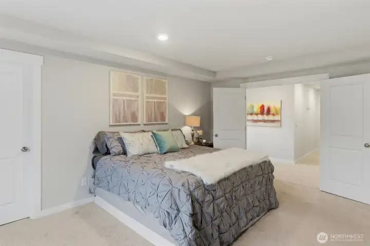 Double doors leading into the Primary Suite.  The closet to the left is the smaller walk-in.