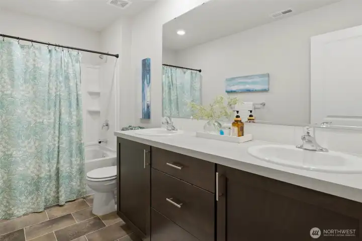 Double sinks in the upstairs bathroom, along with a tub/shower combo.