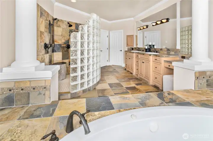 Owner Suite bathroom with large glass shower, deep jetted soaking tub, 2 sinks and tons of storage. Heated slate flooring. Owner Suite bathroom with large glass shower, deep jetted soaking tub, 2 sinks and tons of storage. Heated slate flooring.
