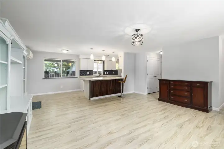 View from the living room to the dining room and kitchen.  New laminate flooring throughout.