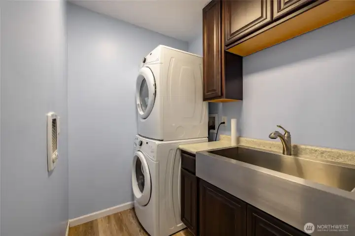 Laundry room with large sink and cupboards