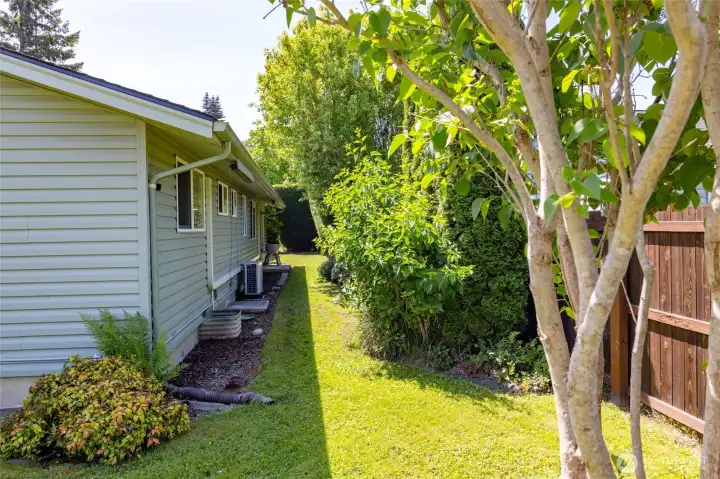 Back yard has shrubs for privacy and is fully fenced.  Hot and cold water faucets are just outside the back door off the garage.