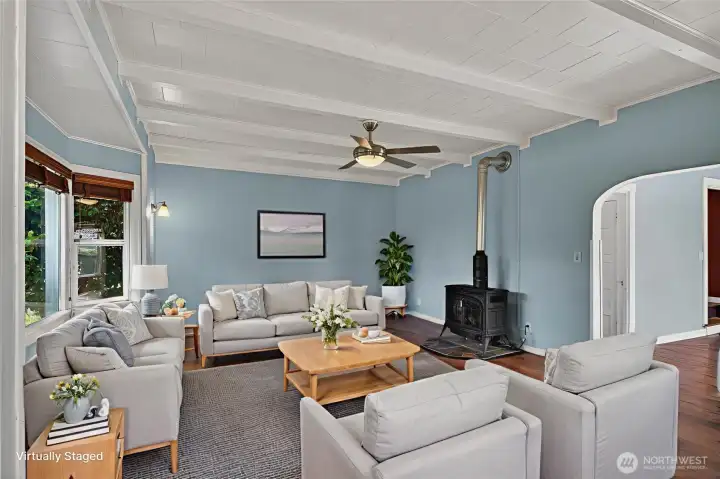 Spacious living room with elevated ceilings and gas free standing stove. Spacious living room with elevated ceilings and gas free standing stove.