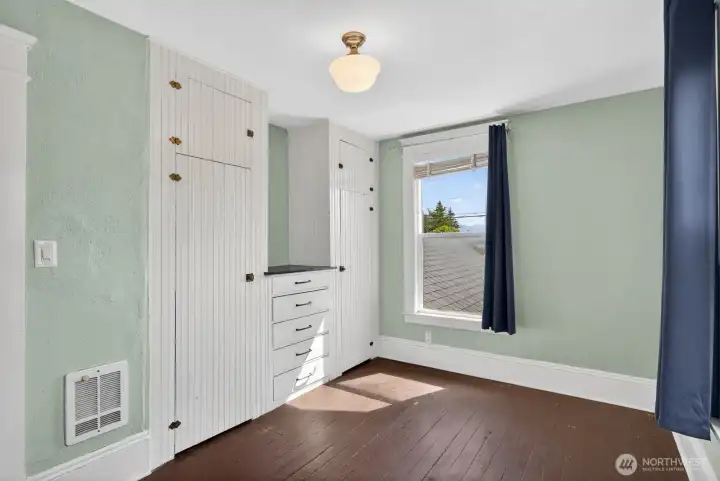 Bedroom #2 offers natural light and original built-in shelves. Bedroom #2 offers natural light and original built-in shelves.