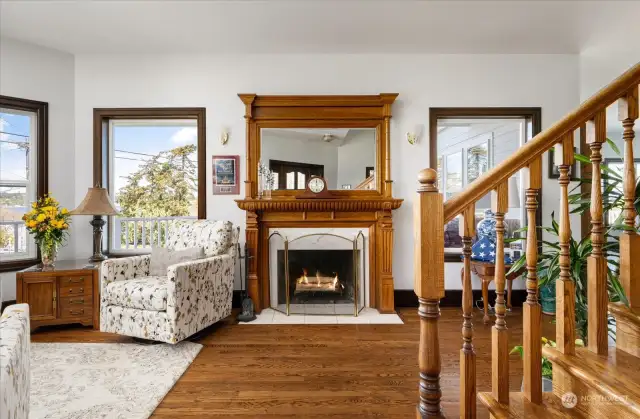 Foyer, wood floors and a cozy fireplace.