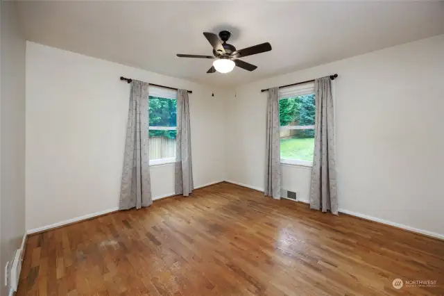 Upstairs bedroom #2 with hardwood floors and ceiling fan.