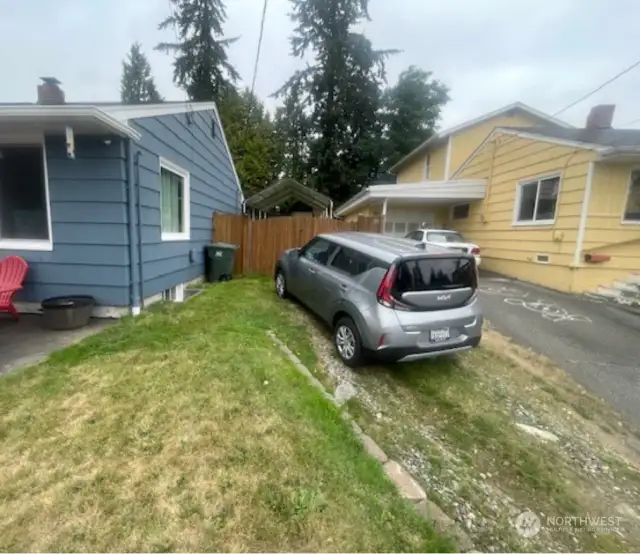 Additional off street parking up next to house.  In front of the car is a double gate to the large carport, perfect for a boat or RV.