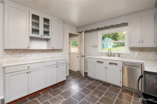 Updated kitchen with added cabinets and counter space. Door from kitchen to backyard and to lower level. Could be separate entrance for lower level ADU.