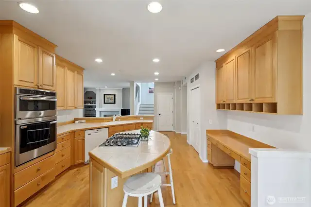 Island with built-in range and Kitchen cabinets going to ceiling