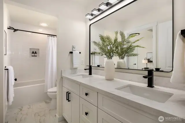 Upstairs full bathroom with two sinks and generous counter space.