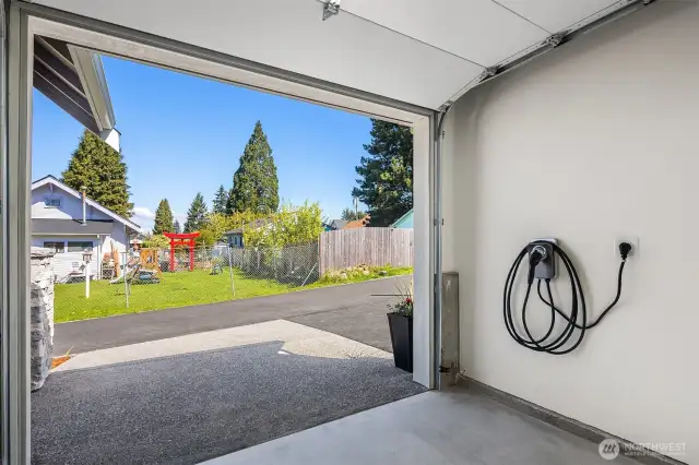 Garage with additional storage and EV charger.
