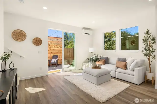 Spacious living room featuring large windows providing natural light.