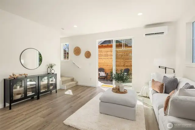 Living room featuring sliding glass doors out to backyard.