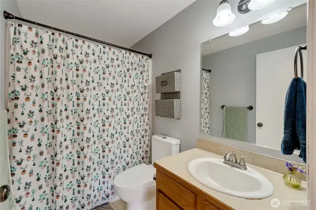 This full bath services the second and third bedrooms and includes a newer toilet.