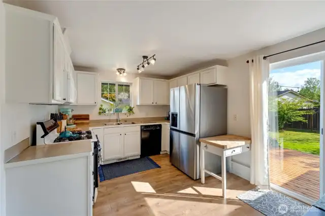This sunny kitchen enjoys garden views and a new refrigerator!