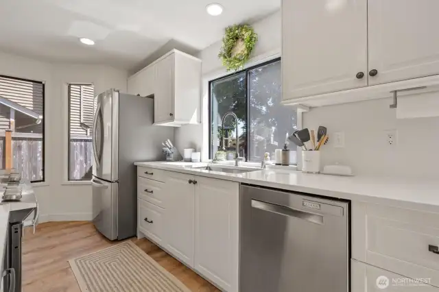 Beautifully remodeled kitchen with undermount sink, quartz countertops, Stainless Steel appliances, new cabinets, new flooring, and LED lighting.
