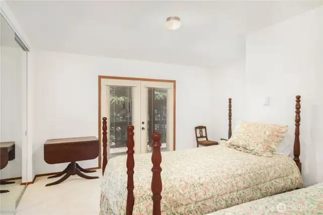 Den/office features French doors leading to the deck and spacious double closets—ideal for work, guests, or extra storage.
