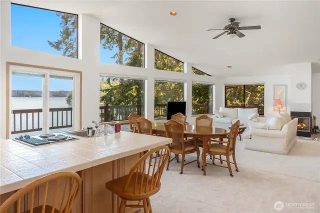 The open floor plan on the upper level offers flexible living space, currently arranged with a dining area, living room, and primary bedroom—ideal for separate living areas or customized to fit your lifestyle.