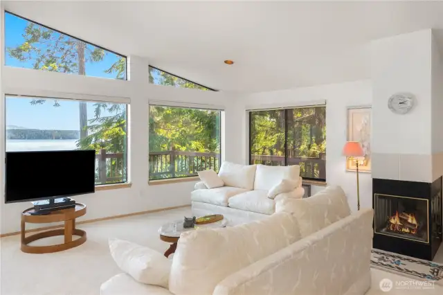 Three-sided fireplace beautifully separates the living room and primary bedroom, providing warmth and ambiance to both spaces.