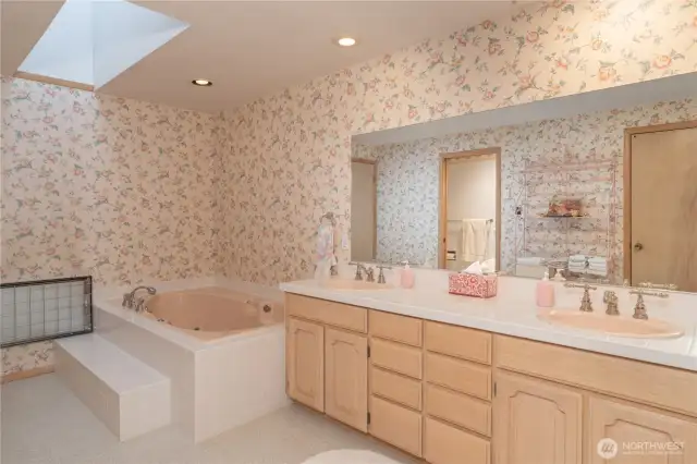 Primary bath offers double sinks, a spacious soaking tub, and a separate walk-in shower—designed for relaxation and convenience.