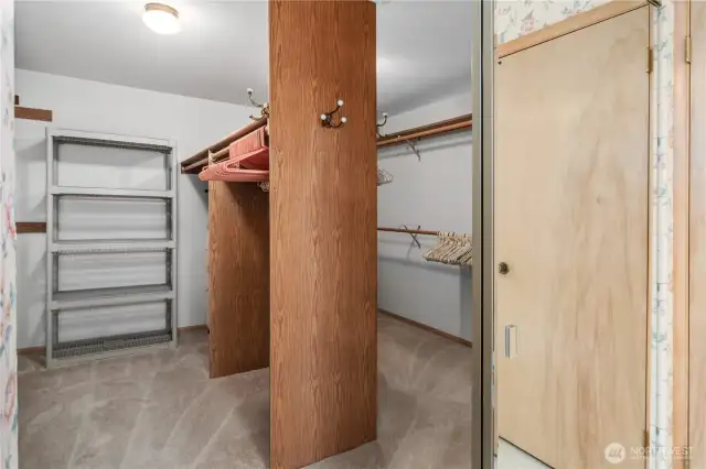 Massive walk-in closet adjacent to the primary bathroom provides ample storage and organization space.