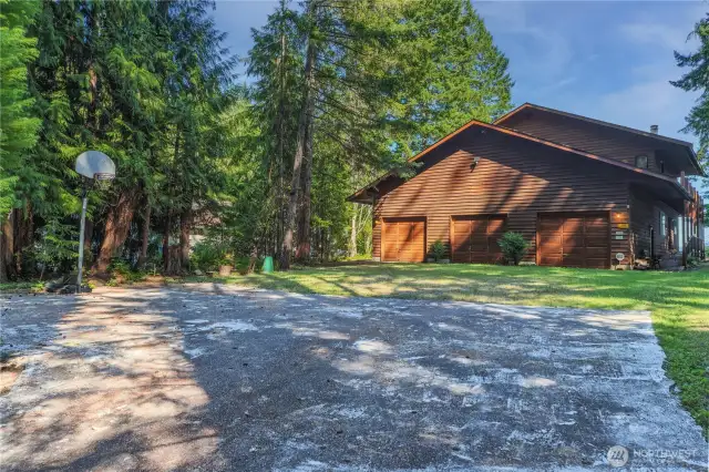 Spacious three-car garage complemented by a versatile sports court—perfect for parking, storage, and active outdoor fun. Relax in the garage sauna at the end of the day. There are stairs in the garage that lead to the upper deck and living area