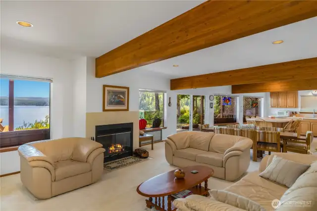 View across the living and dining rooms highlights the open layout, drawing your eye toward the inviting, well-appointed kitchen.