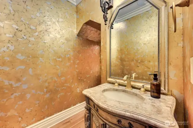 Powder room with gold foil wall finish