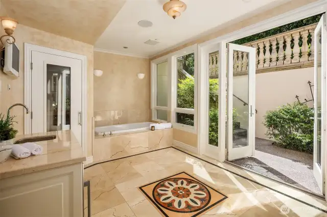 Lower level spa with sauna, cold bar and hot tub opens to the terrace