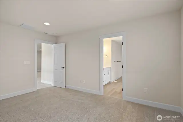 Primary bedroom suite with luxurious master bathroom that has double sinks