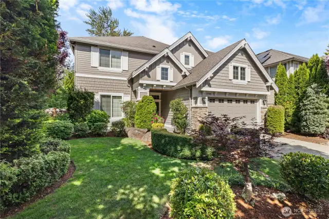 Manicured front yard framed by mature plantings.